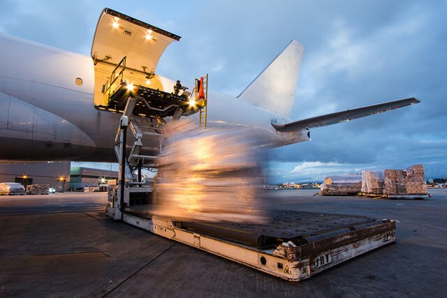 A photo of a plane being loaded with materials.