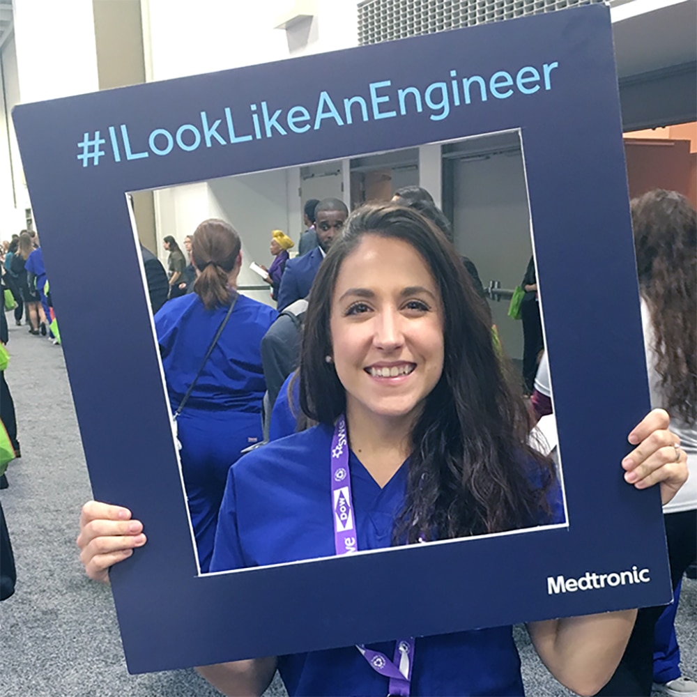 Jessica Weber at SWE holds a sign reading #ILookLikeAnEngineer