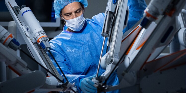 Surgeon with Medtronic Hugo robotics system.