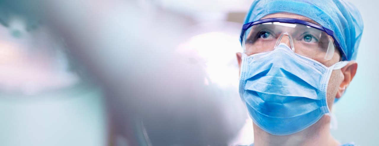 Photo of a healthcare professional wearing a mask in a hospital, thumbnail image crop