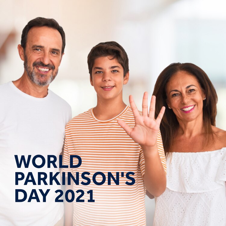 Father, mother and son standing together with son holding up hand for a high five