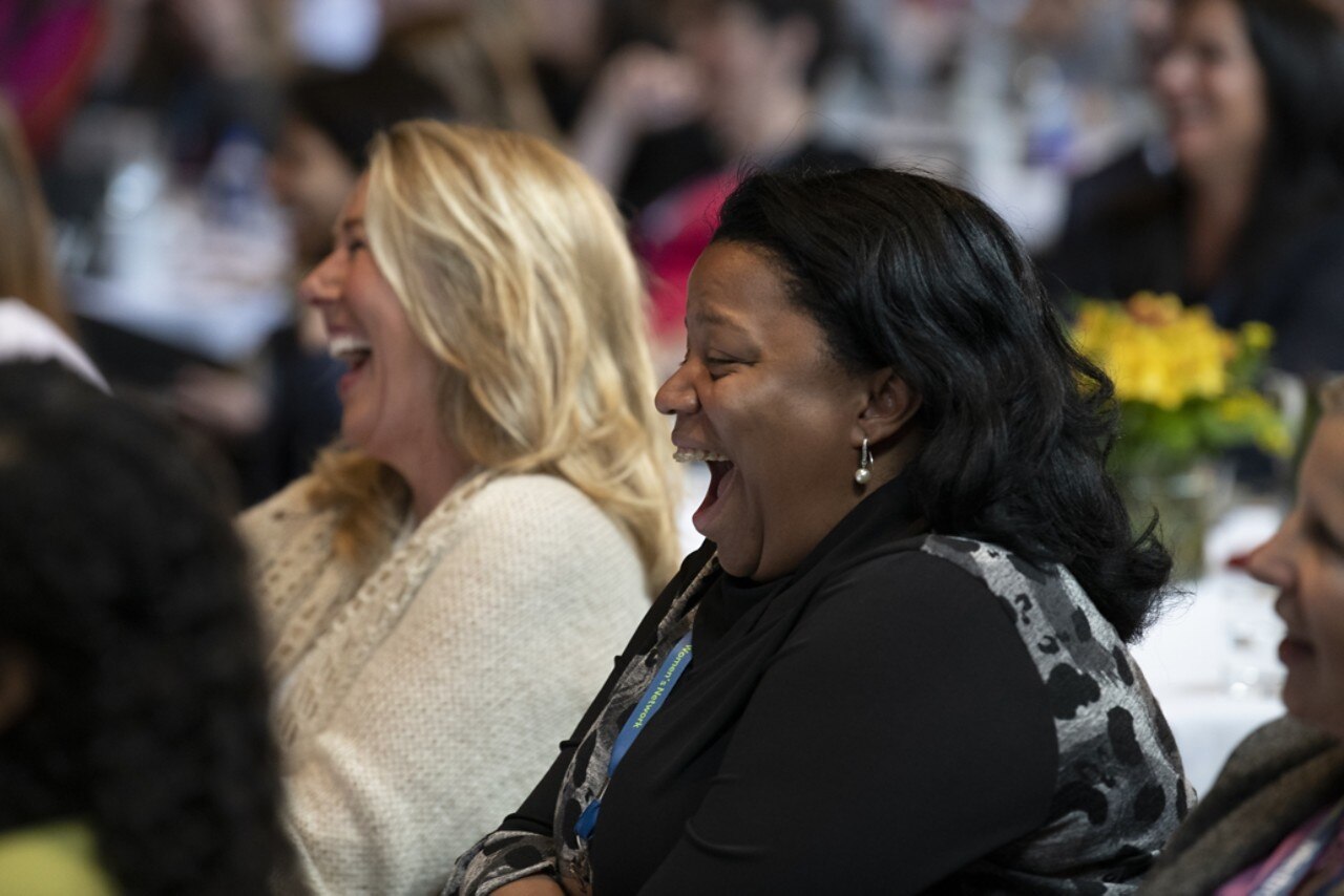 Audience laughing at a conference