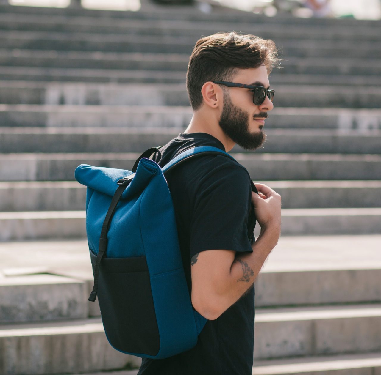 Guy with backpack walking by steps