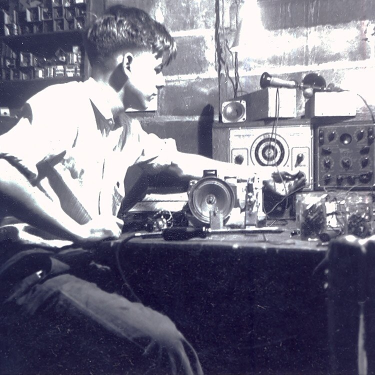 Black and white image of a young Earl Bakken in the family basement