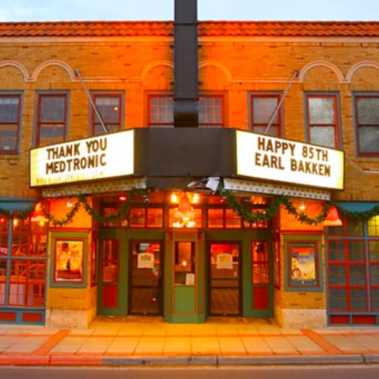Image of front of movie theater with the message "Thank you Medtronic. Happy 85th Earl Bakken" on the marquee. 
