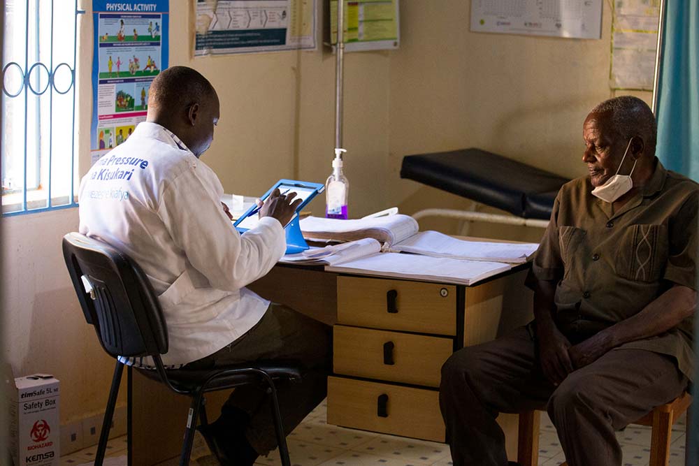 Doctor with tablet visiting a patient
