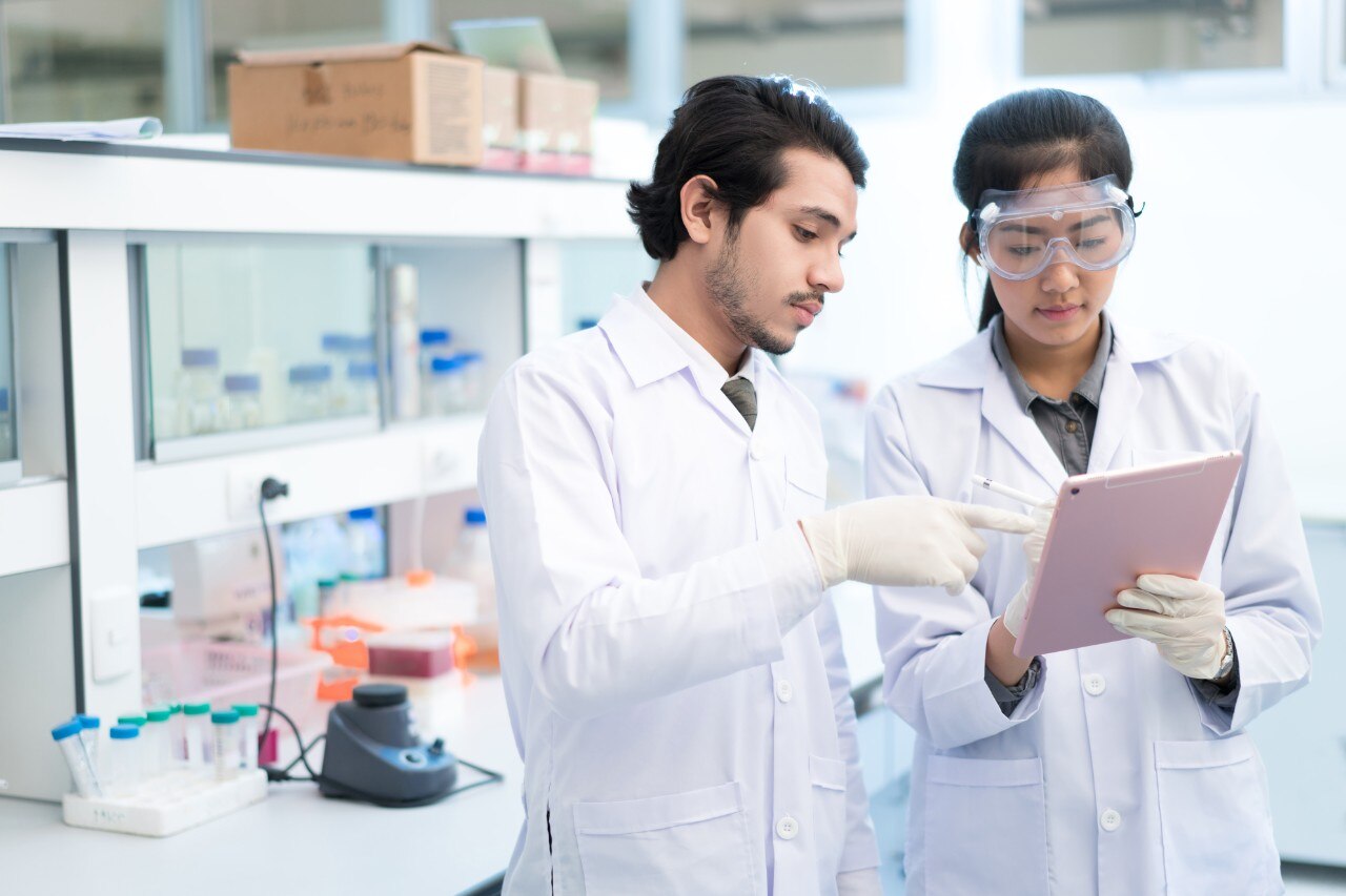 Image depicting two scientists looking at paperwork