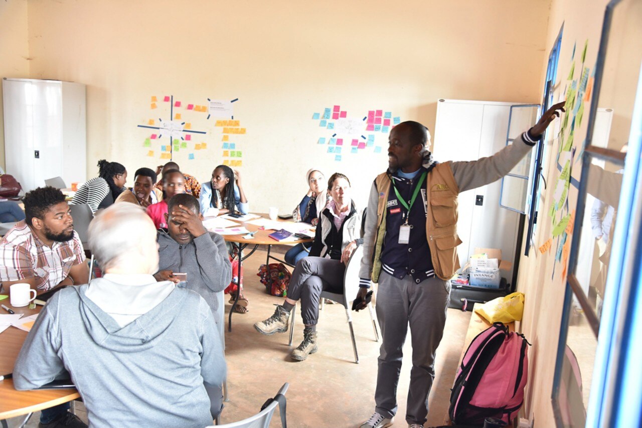 A workshop in Rwanda for a humanitarian organization with participants sitting at desks